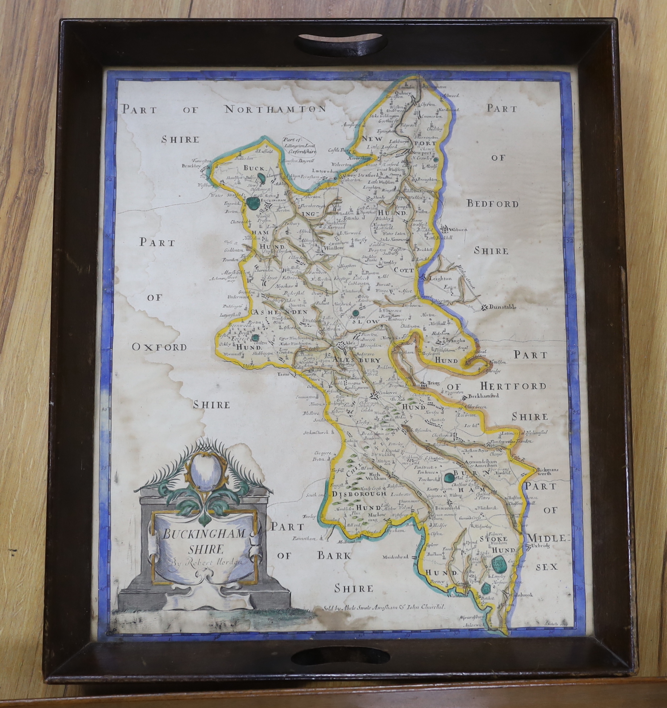 An 18th century hand coloured map of Wales, framed as a twin handled drink’s tray, together with another after Robert Morden, Buckinghamshire, largest 58cm wide (2)
